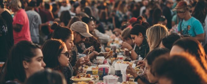 individuals enjoying tacos at Helluva Taco Fest at PK Lake